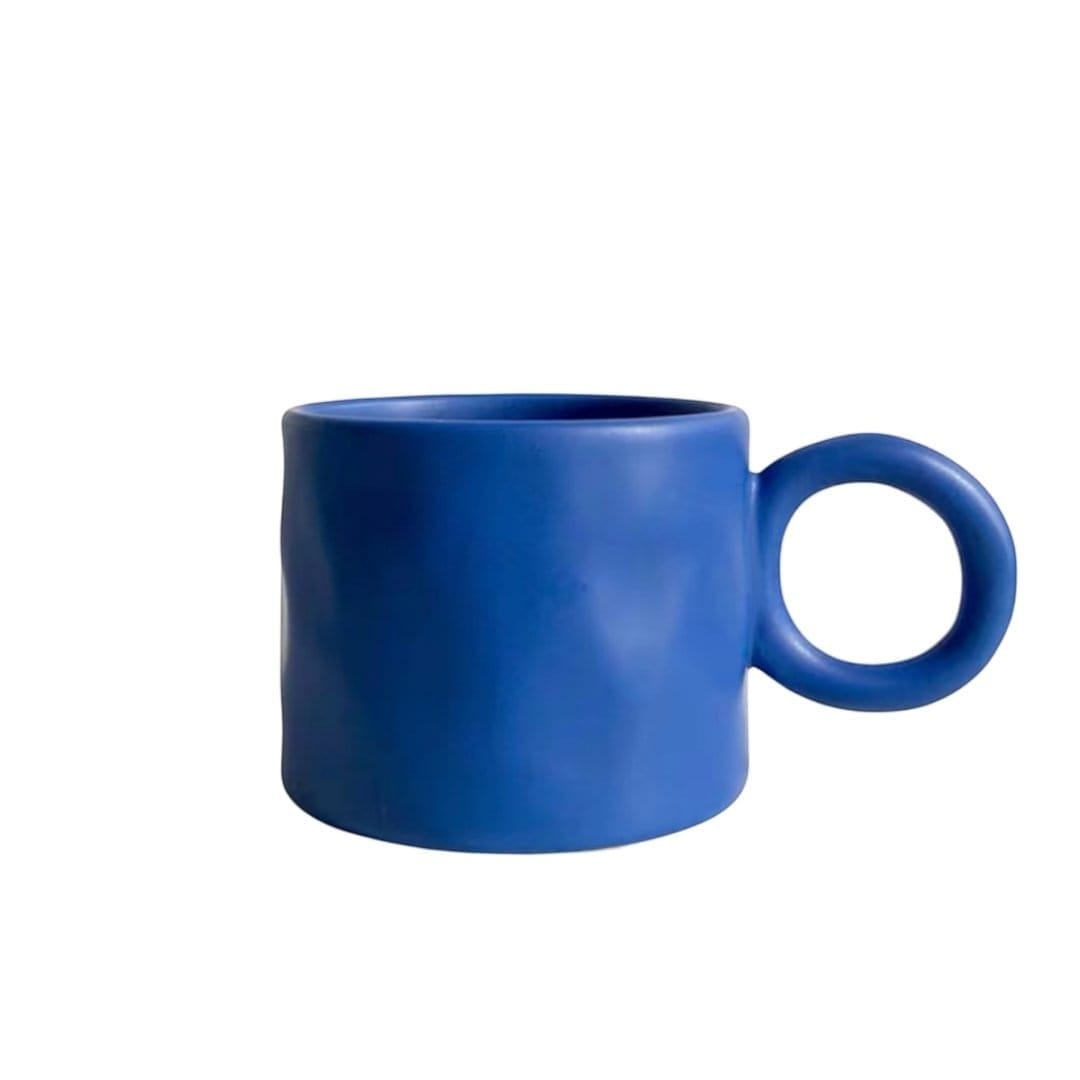A matte blue ceramic dumbo mug with a minimalist rounded handle perfect for everyday use