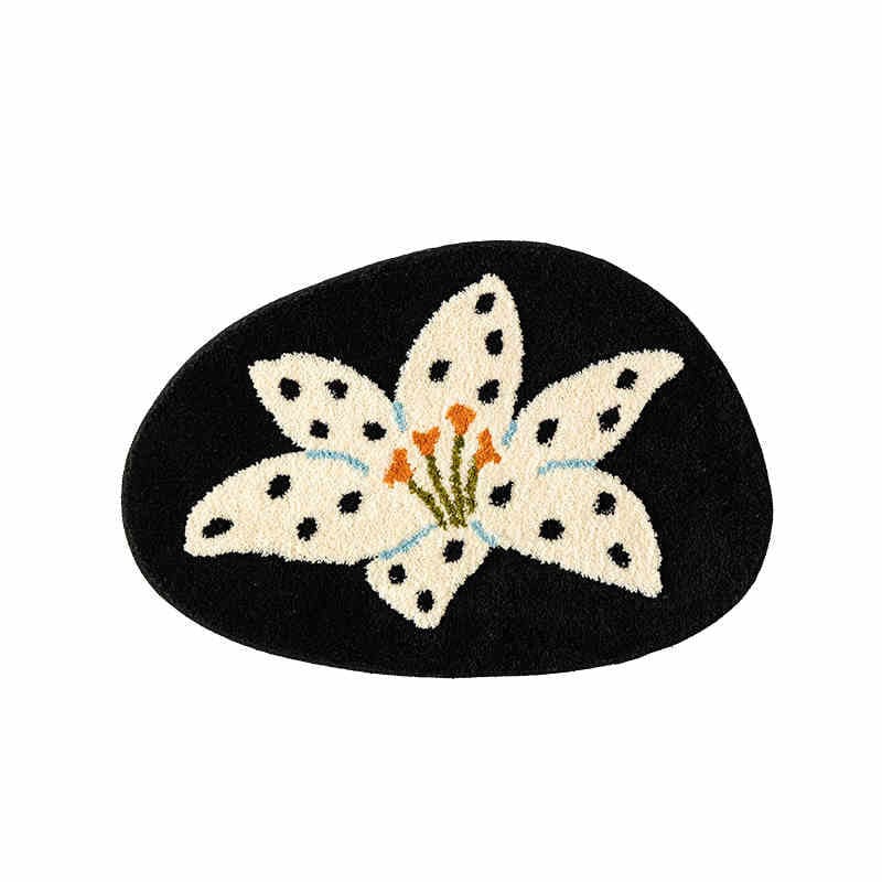 Decorative mat with a white flower design on a black background