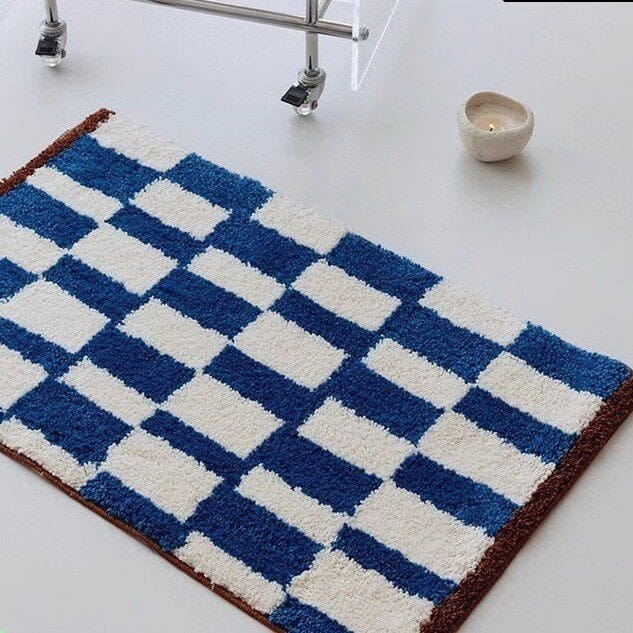HOMELIVY blue and white checkered plush bath mat with brown trim. Retro checkerboard design.