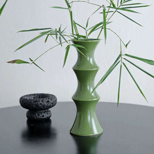 A sleek olive-green ceramic bamboo vase with segmented bamboo-inspired design for home decor