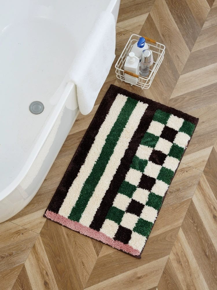 Retro checkered plaid rug in green white and black striped pattern with pink border for bathroom use
