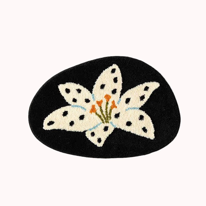 Decorative mat with a white flower design on a black background
