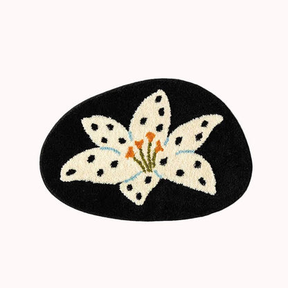 Decorative mat with a white flower design on a black background