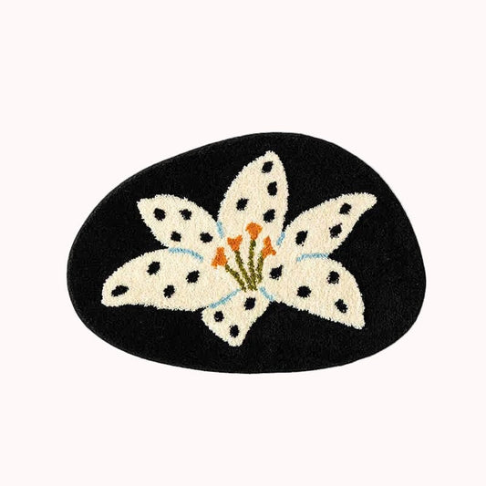Decorative mat with a white flower design on a black background