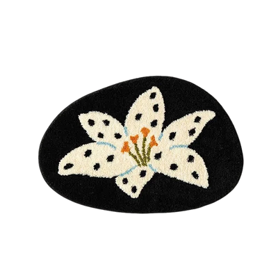 Decorative mat with a white flower design on a black background