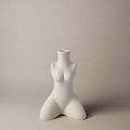 White ceramic body shaped vase featuring a stylized female torso design for decorative use