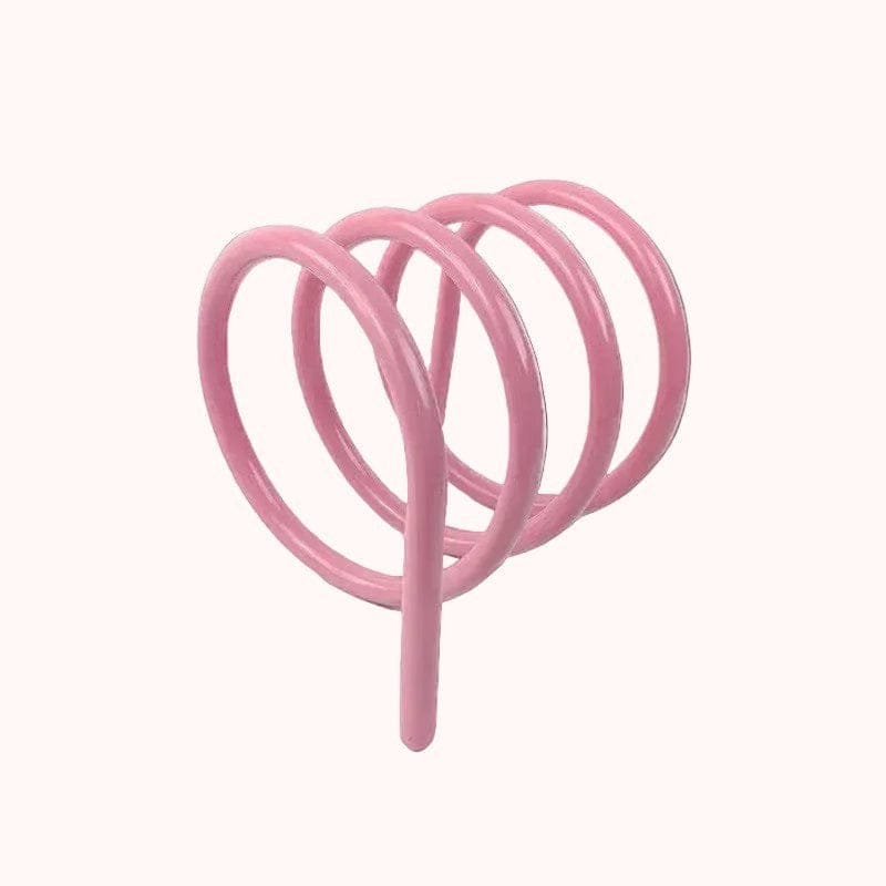 Pink spiral metal spring book holder designed as a bike rack for holding books securely and stylishly