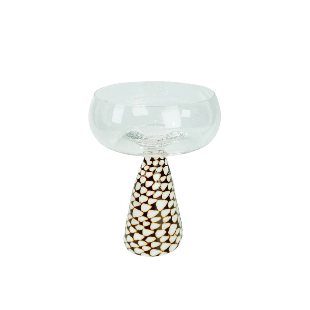 Clear glass conch shell coupe glass with a teardrop-shaped base and cream and dark brown pebble pattern decoration