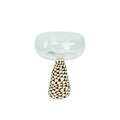 Clear glass conch shell coupe glass with a teardrop-shaped base and cream and dark brown pebble pattern decoration