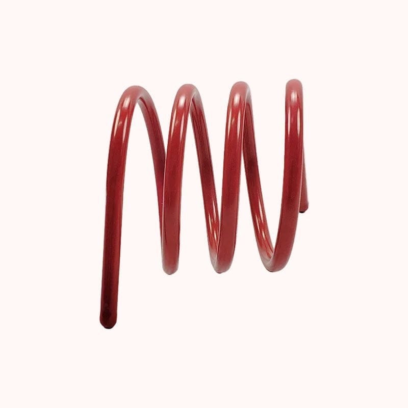 A glossy red coiled metal spring book holder with a smooth uniform finish for holding books securely