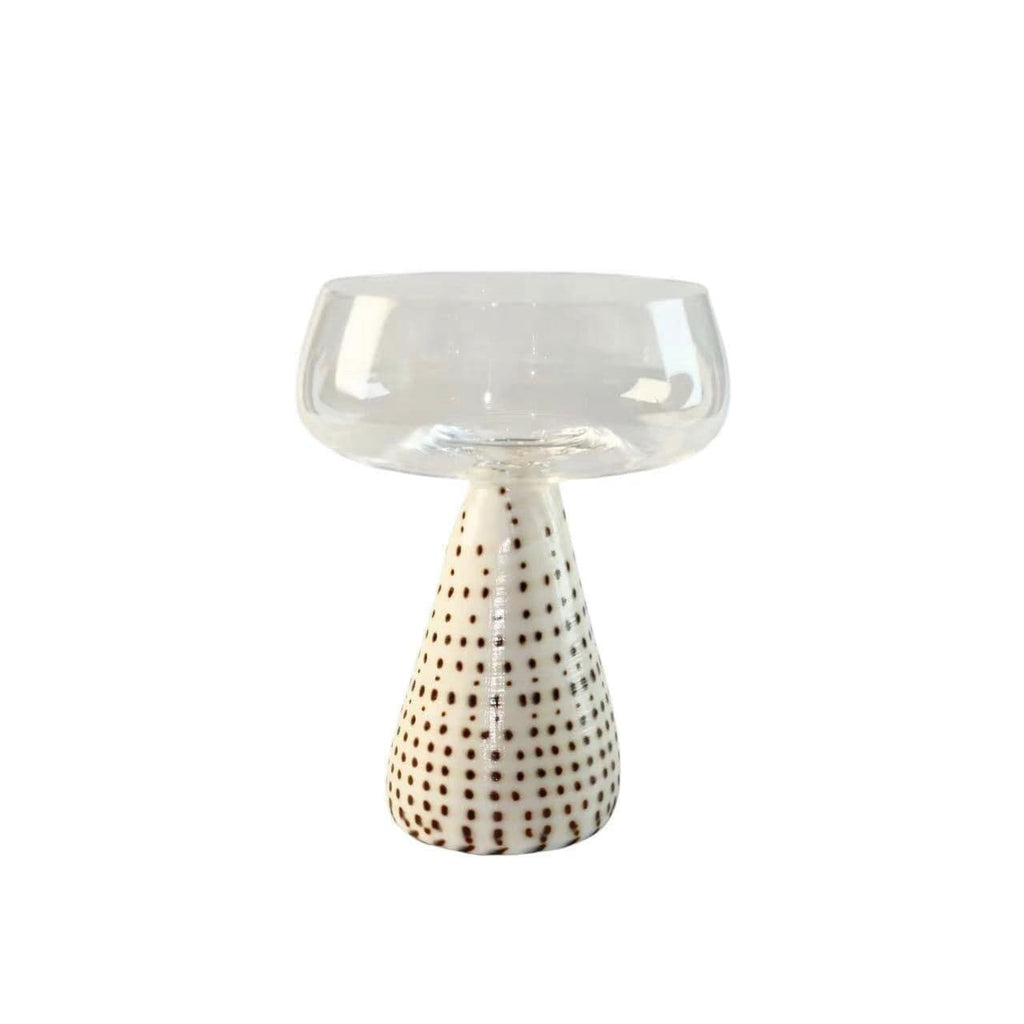 Clear glass conch shell coupe glass with white dotted ceramic pedestal base for elegant serving