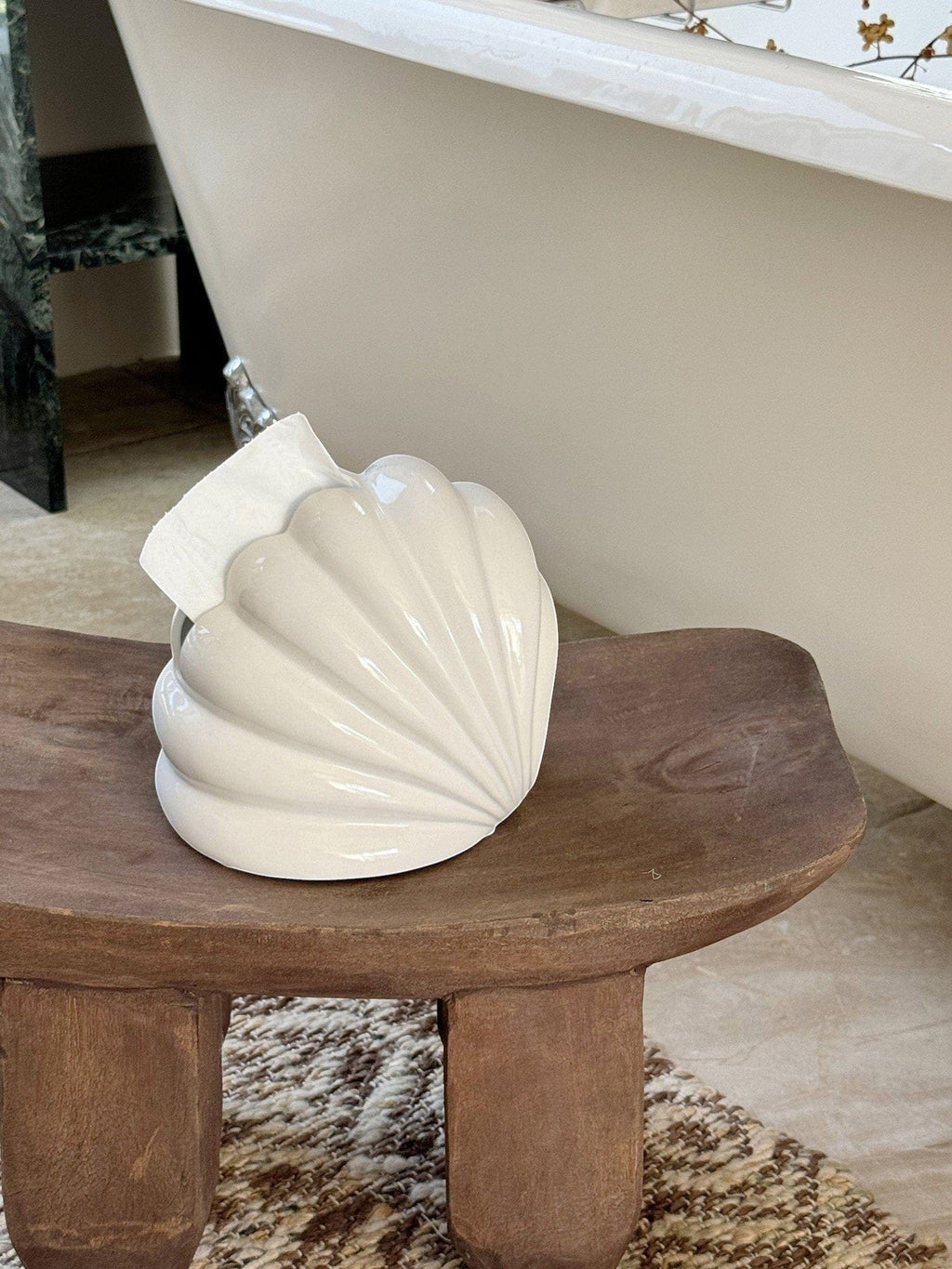 Cream-colored ceramic seashell-shaped toilet paper holder shell tissue holder with a glossy finish