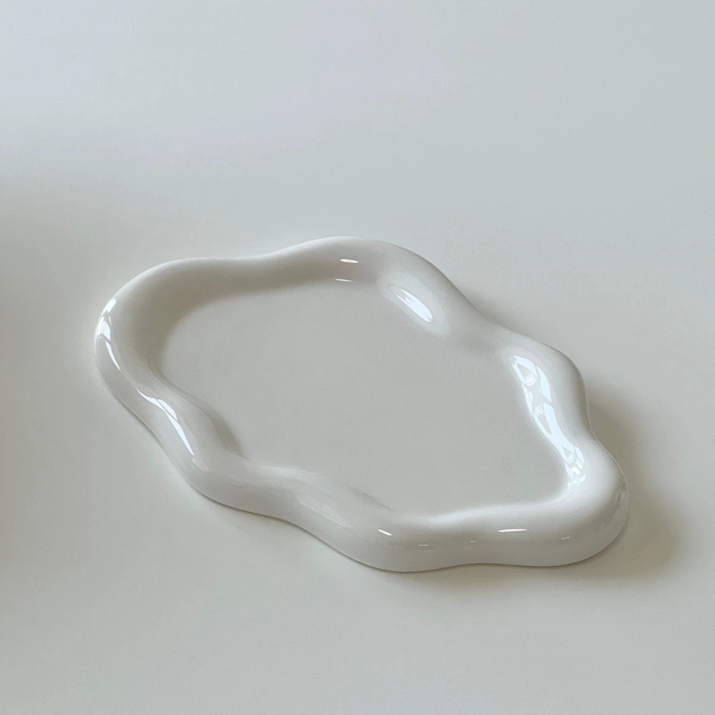 A smooth glossy white ceramic cloud tray with an organic shape perfect for serving or decor