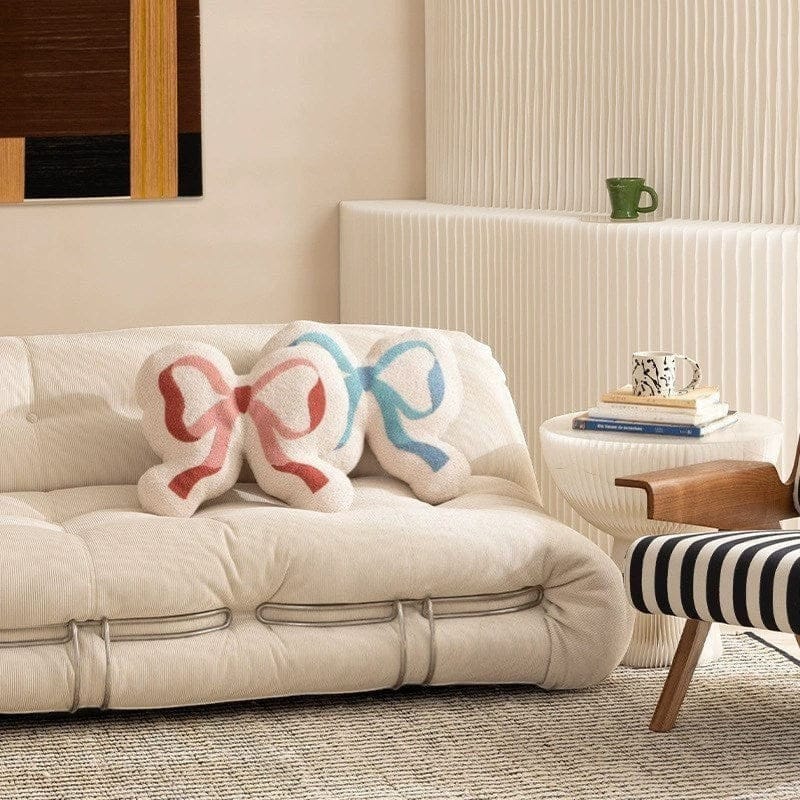HOMELIVY cream cushion shaped like a double ribbon bow with pink and blue accents, 44x39cm.