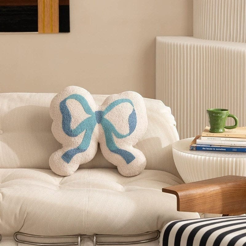 HOMELIVY cream textured pillow with a blue ribbon bow design, 44 x 39 cm.