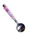 HOMELIVY stainless steel spoon featuring a decorative handle with pink and iridescent beads on a black background.