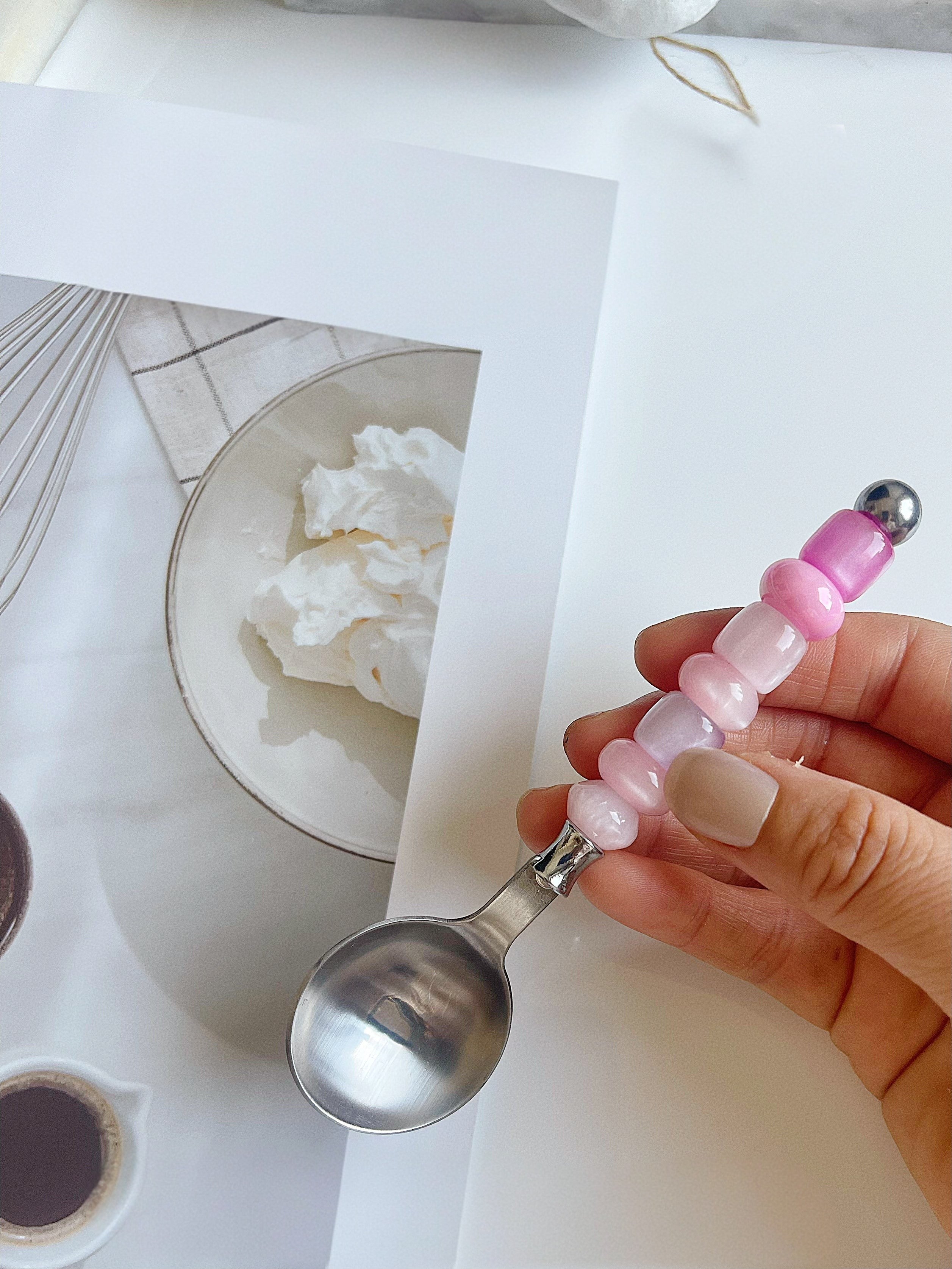 HOMELIVY stainless steel spoon featuring a handle decorated with pink and white gradient glass beads
