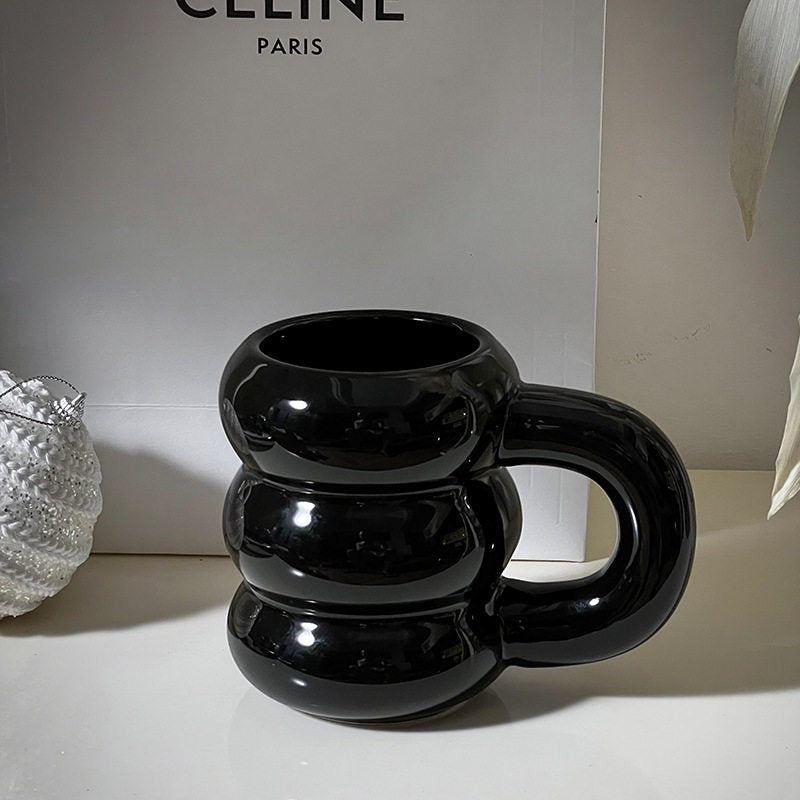 HOMELIVY black ceramic bubble coffee mug with sculptural stacked-ring design and oversized handle.