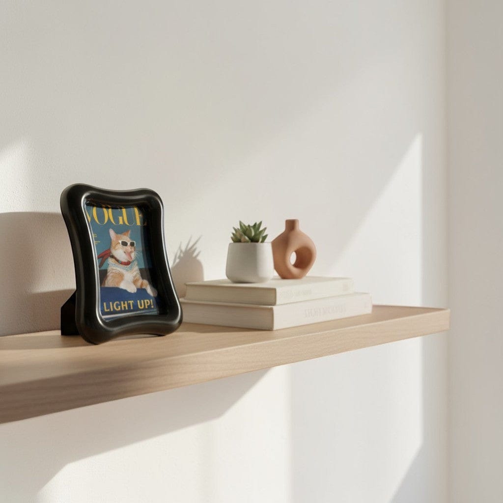 HOMELIVY black wavy acrylic photo frame displaying a cat wearing sunglasses and a scarf.