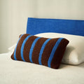 Boucle striped cushion cover in taupe and powder blue on a neutral bed