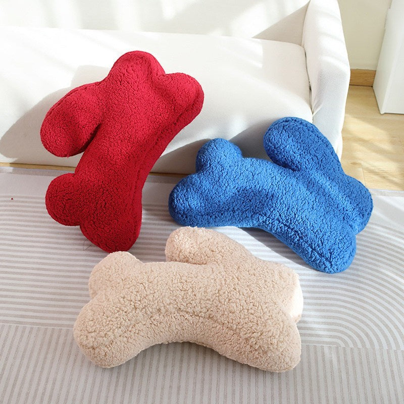 HOMELIVY plush bone-shaped throw pillows in red, blue, and beige, perfect for kids' rooms or home decor.