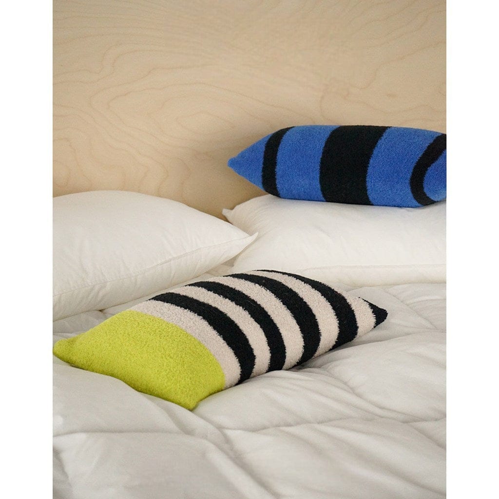 HOMELIVY Bouclé Stripe Lumbar Pillow in lime green, black, and cream with a blue and black striped pillow behind it.