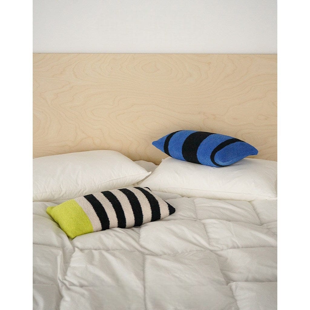 HOMELIVY Bouclé Stripe Lumbar Pillow in blue and black, and a second pillow with black and white stripes and a lime green end.