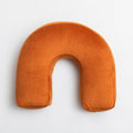 HOMELIVY burnt orange velvet sculptural arch cushion with soft suede-like finish.