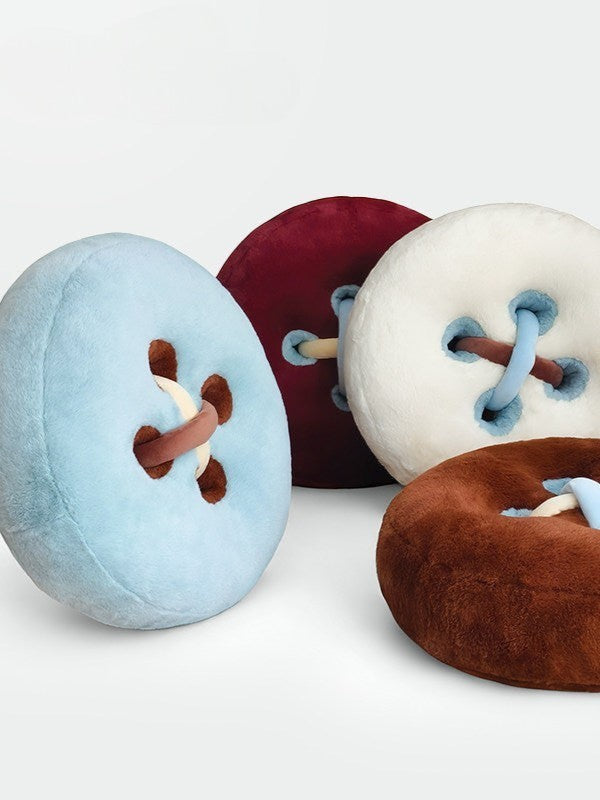HOMELIVY Button Plush Cushion in light blue, burgundy, cream, and brown. Soft, round decorative pillows.