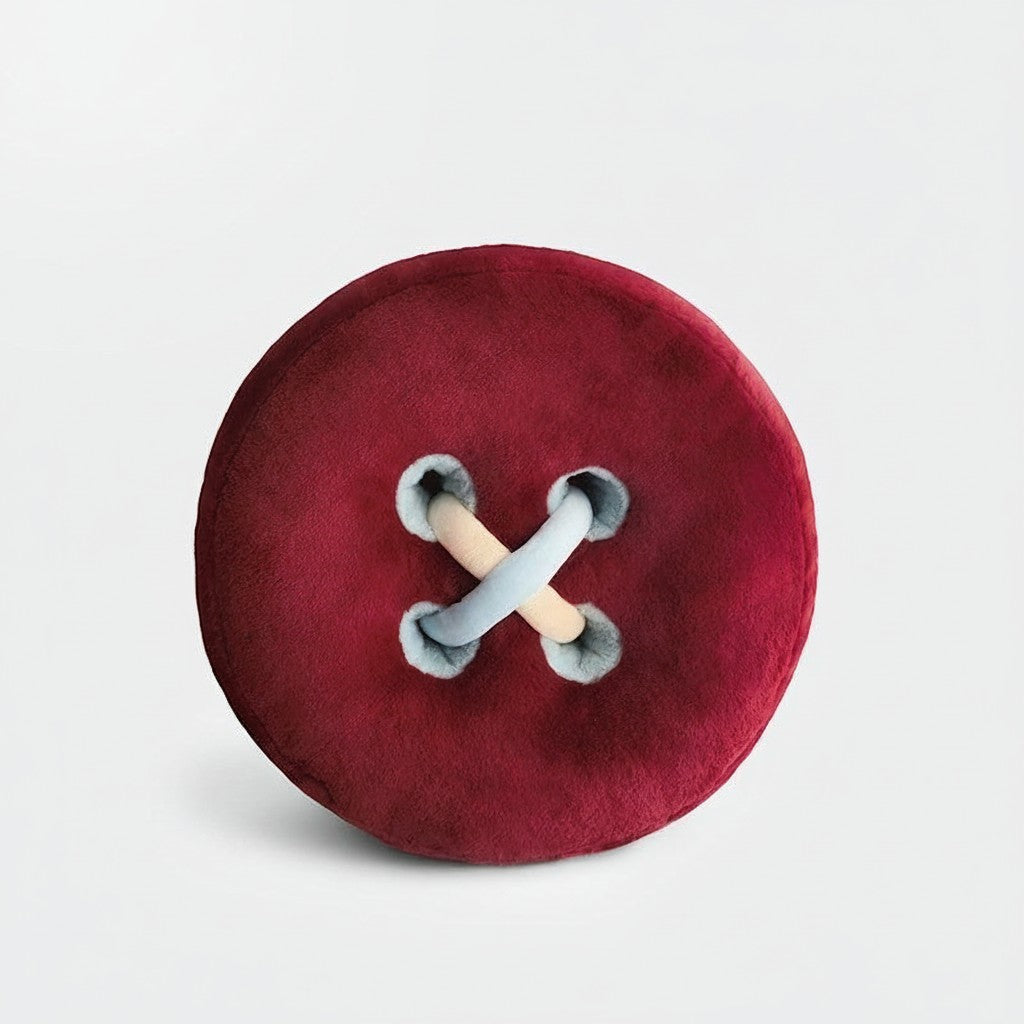 HOMELIVY plush cushion designed as a large, round, burgundy button with light blue and beige thread detail.
