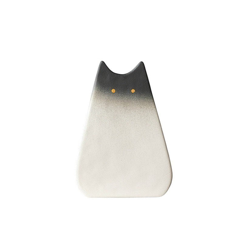 HOMELIVY minimalist ceramic cat vase with a black-to-white ombre gradient and two small yellow dot eyes.