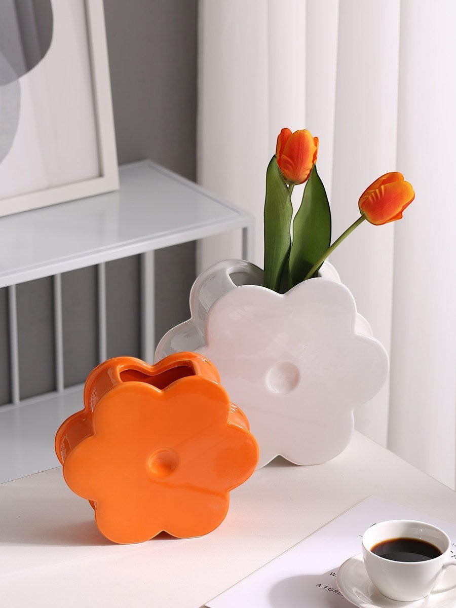 HOMELIVY ceramic flower shaped vases in glossy white and orange, displayed on a table with orange tulips.