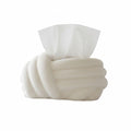 HOMELIVY cream white ceramic tissue box cover with sculptural knot design. A hand is shown pulling a tissue.