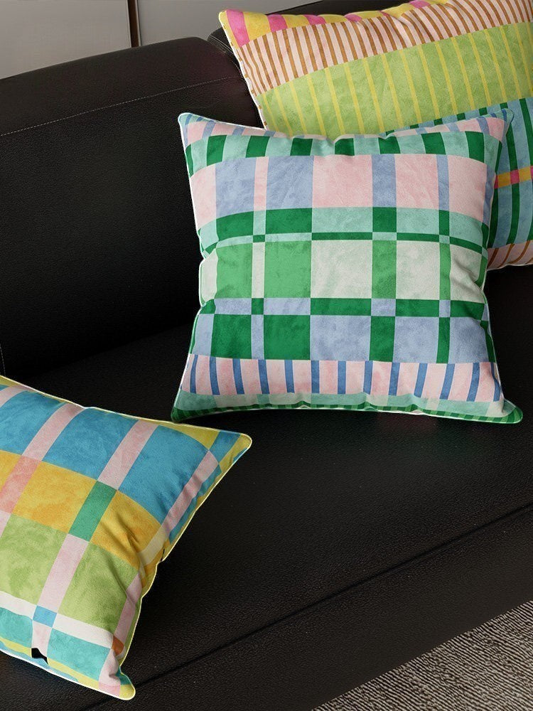 HOMELIVY maximalist throw pillows featuring vibrant checkered and striped patterns in green, pink, blue, and yellow.