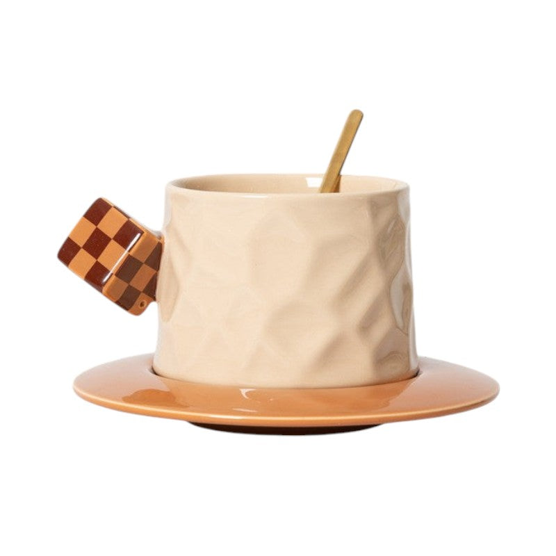 HOMELIVY beige ceramic mug with a textured surface, brown checkerboard cube handle, and matching saucer with spoon.