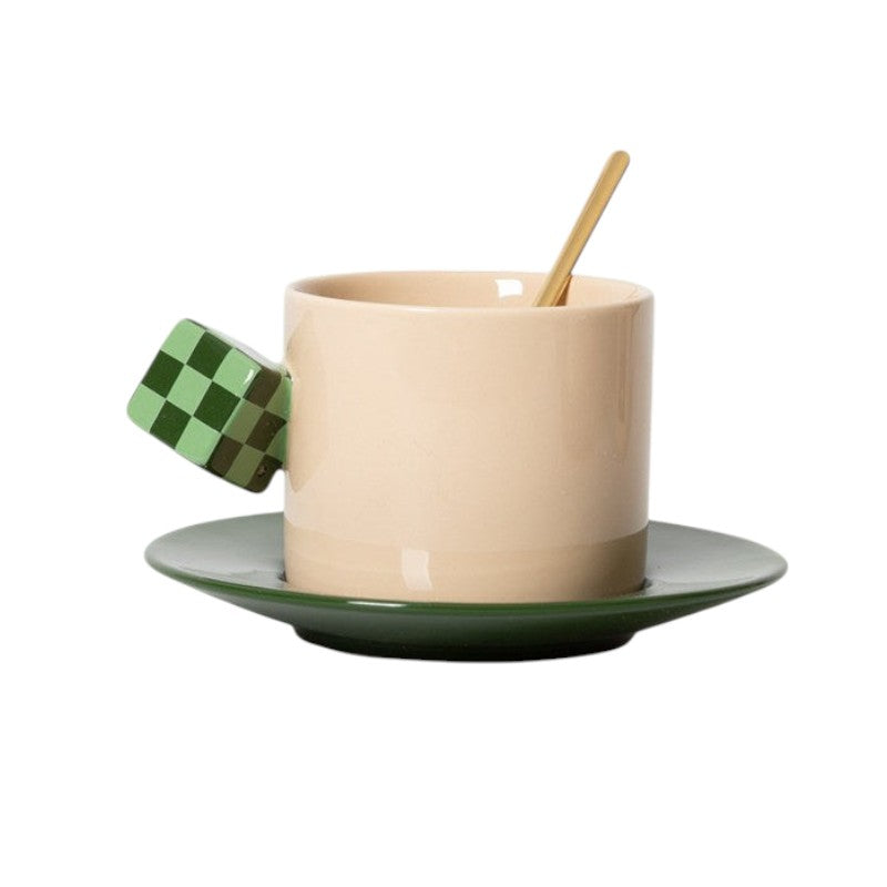 HOMELIVY beige ceramic mug with a green checkerboard cube handle and matching green saucer with a gold spoon