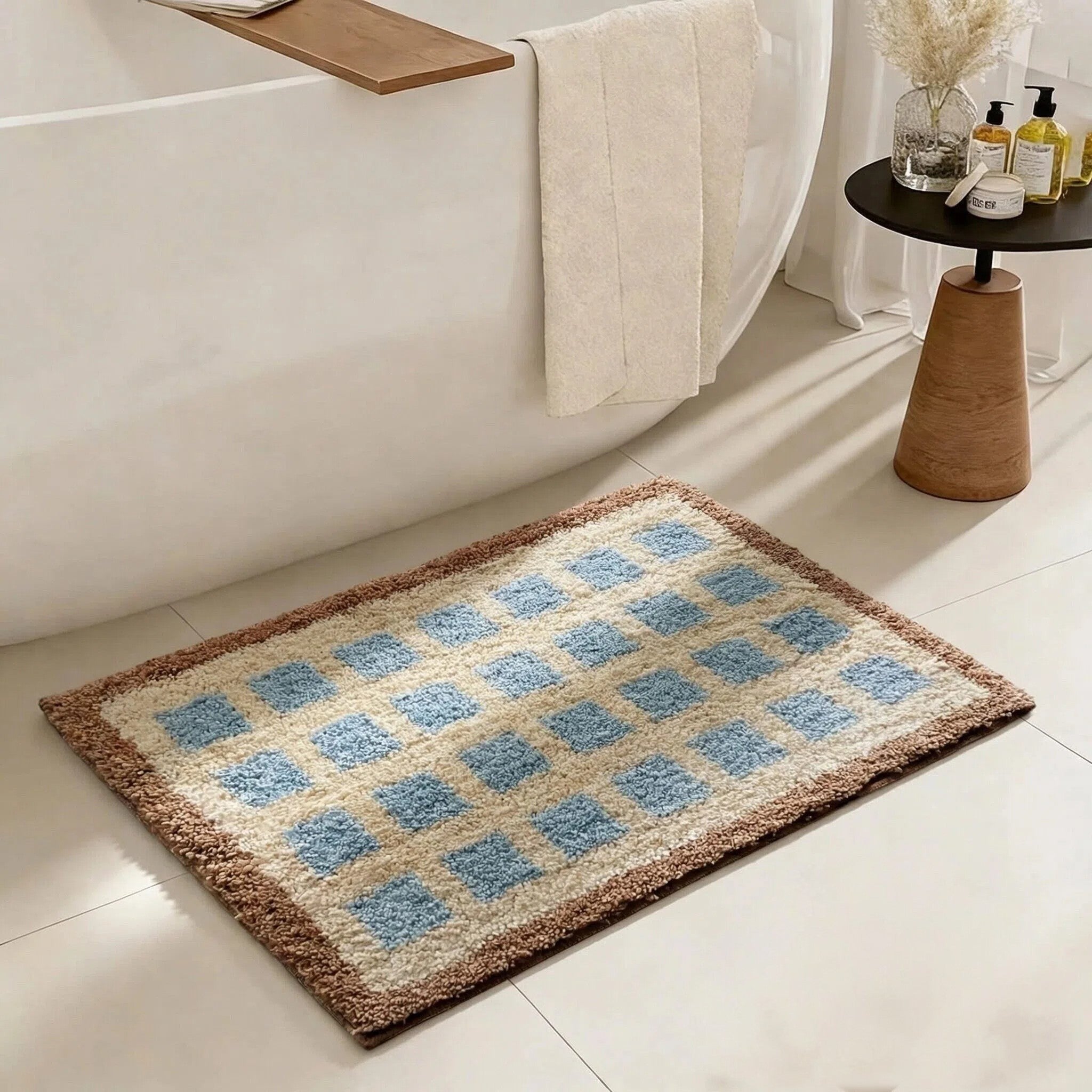 HOMELIVY rectangular bath mat with a blue and cream checkered pattern and a textured brown border on a tiled floor.