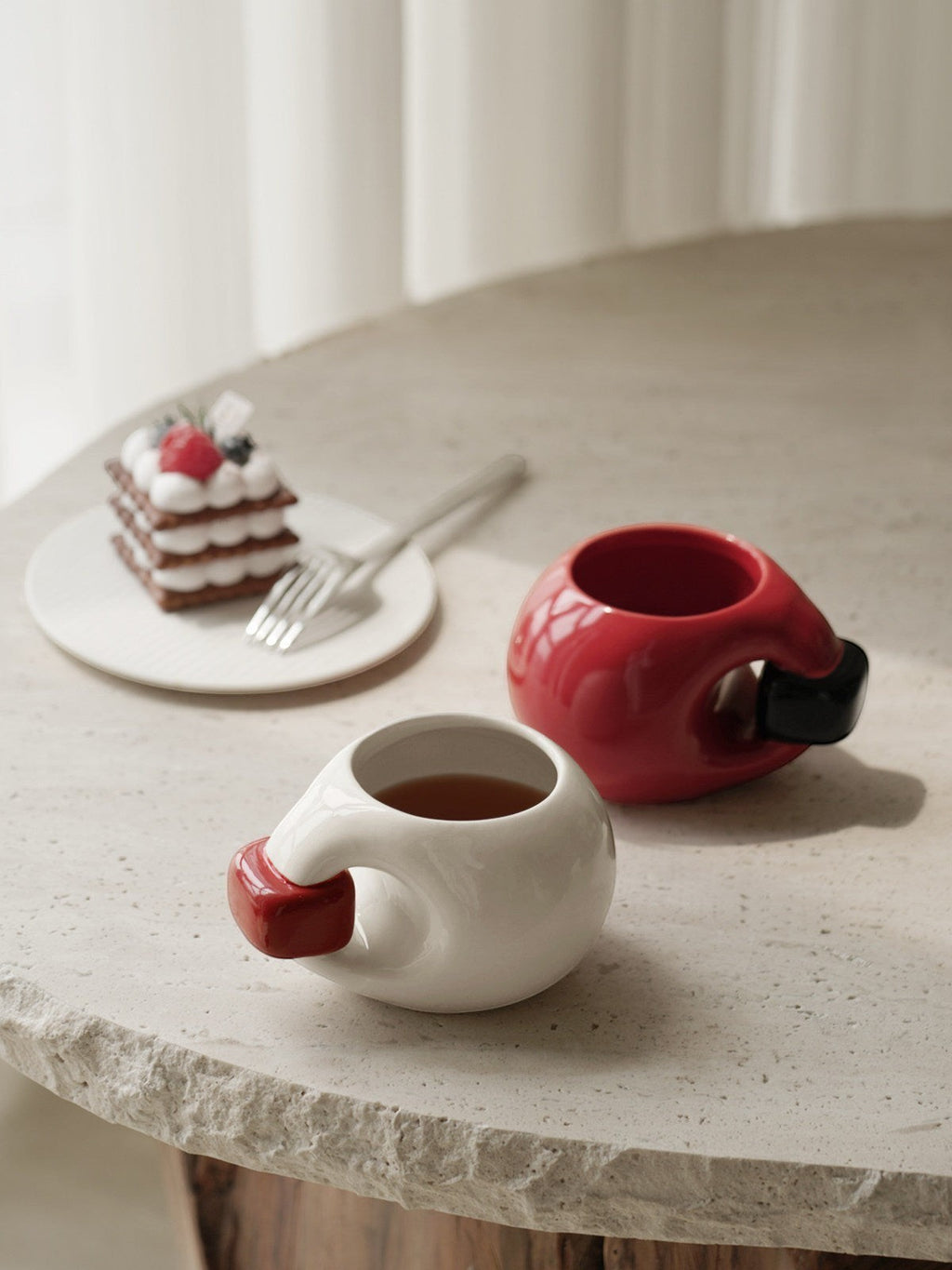 HOMELIVY chunky round ceramic mugs in red and white with contrasting handles on a stone table with dessert