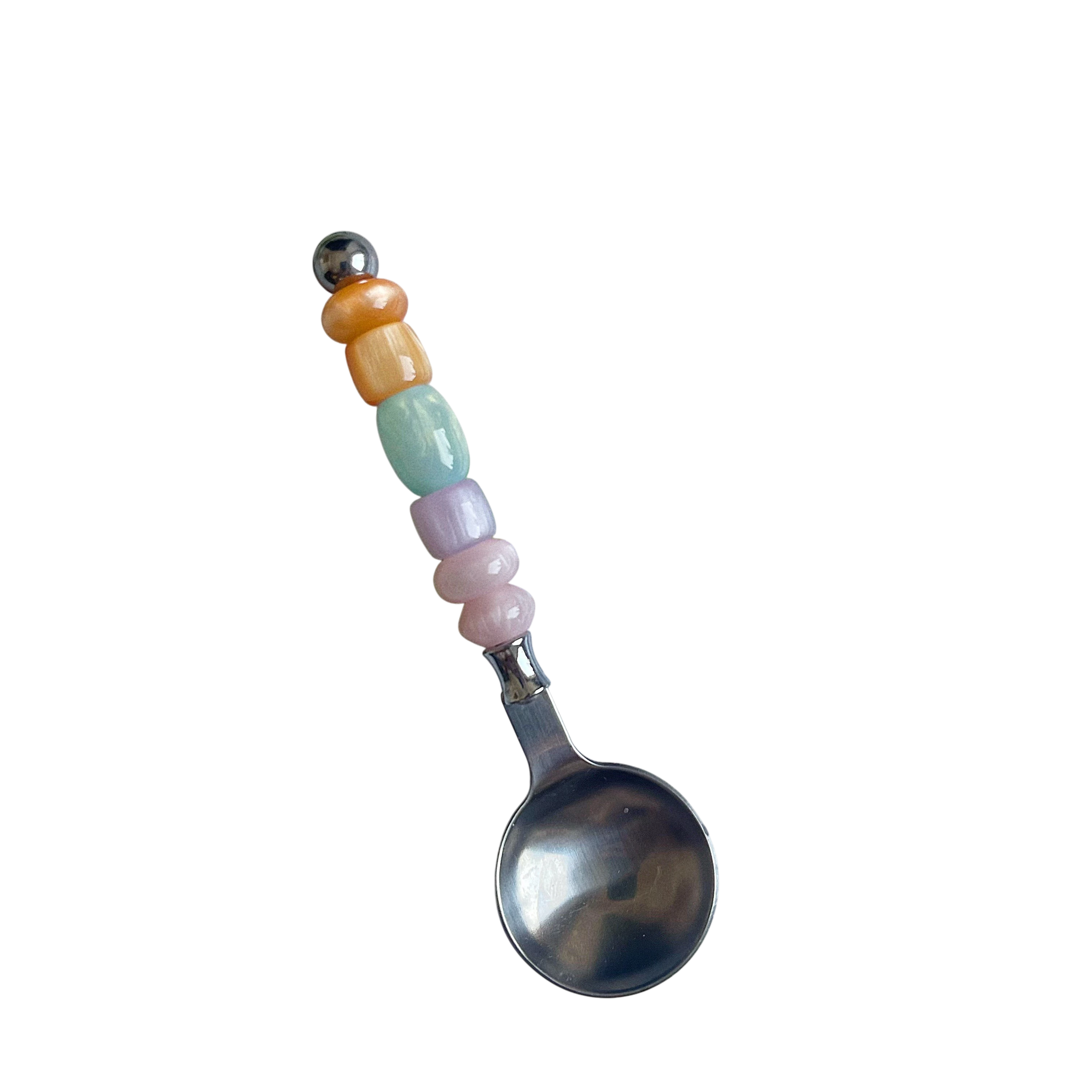 HOMELIVY colorful beaded spoon with pastel resin beads on a stainless steel handle against a black background.