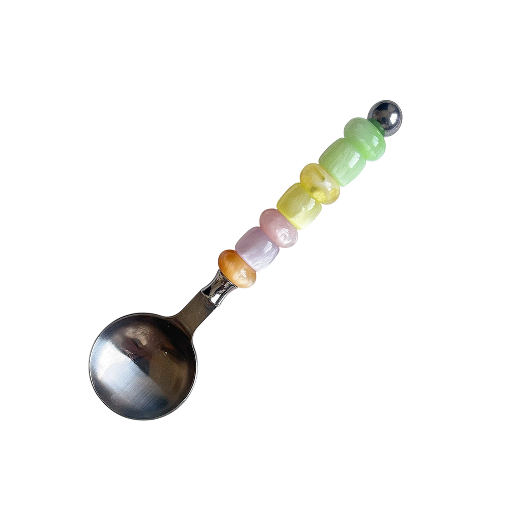 HOMELIVY stainless steel spoon featuring a handle decorated with colorful pastel beads in a vertical row.