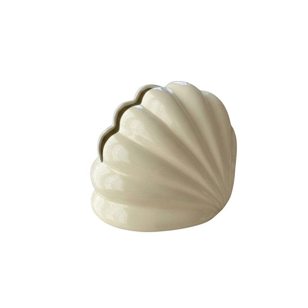Cream-colored ceramic seashell-shaped shell tissue holder with glossy finish and subtle ridges