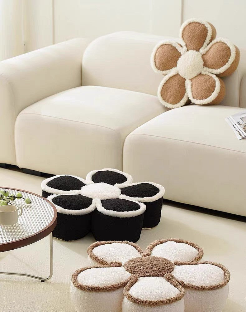 HOMELIVY daisy flower shaped pouf pillows in black, white, and brown plush fabric on a modern living room floor.