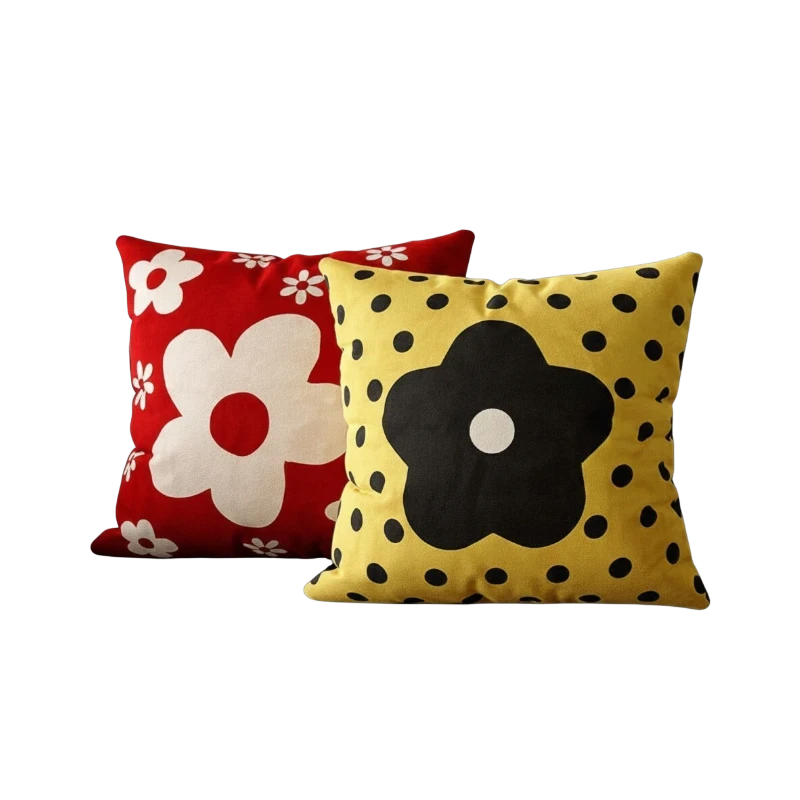 HOMELIVY decorative throw pillows with red floral and yellow polka dot daisy patterns on a black sofa.