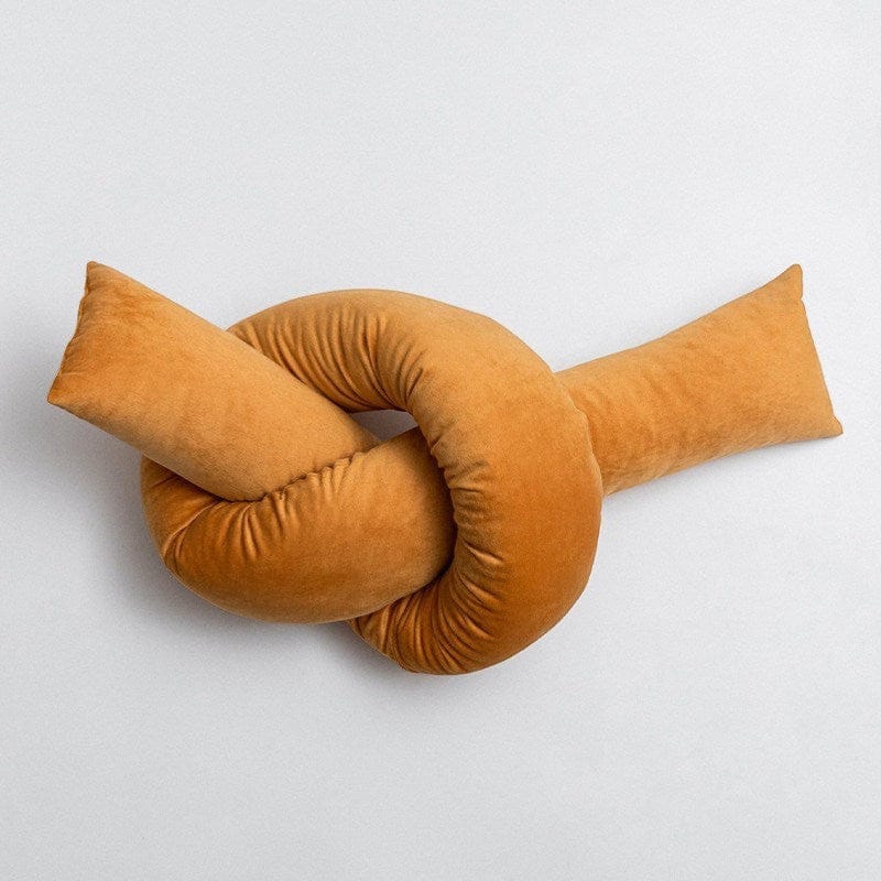 HOMELIVY warm gold velvet knot bolster cushion, soft suede-like texture, sculptural accent for sofa or daybed.