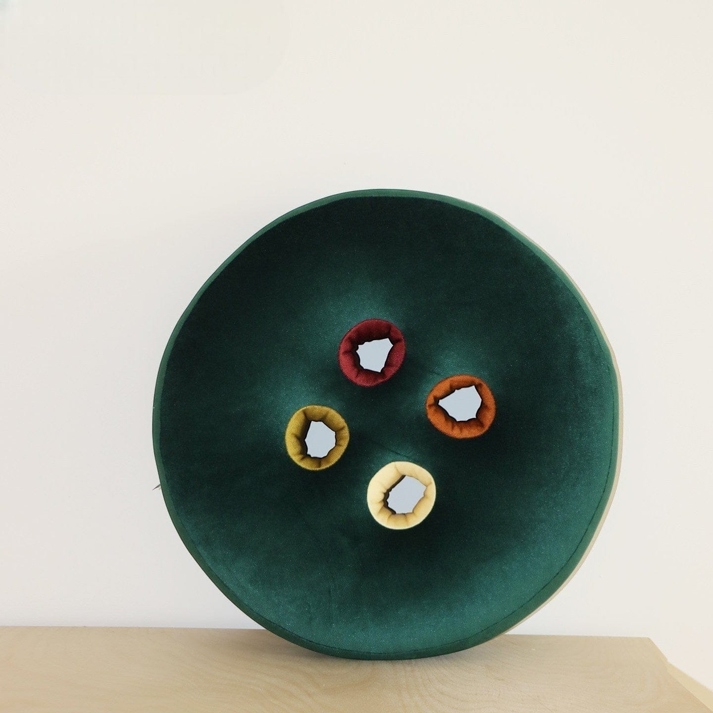 HOMELIVY dark green velvet round seat cushion with four colorful button inserts: red, yellow, orange, and cream.