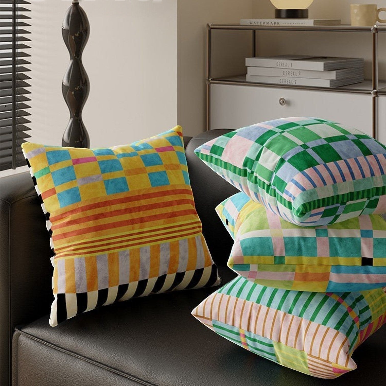 HOMELIVY maximalist throw pillows with vibrant checkered and striped patterns in multi-colored velvet on black sofa.