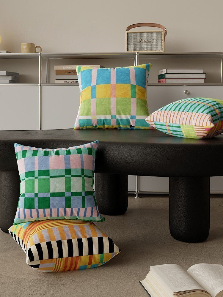HOMELIVY maximalist throw pillows featuring vibrant check and stripe patterns in blue, green, pink, and yellow.