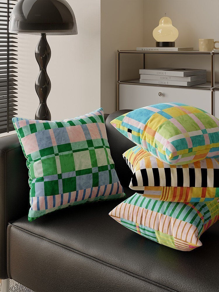 HOMELIVY maximalist throw pillows featuring vibrant checkered and striped patterns in multi-colored pastel tones.