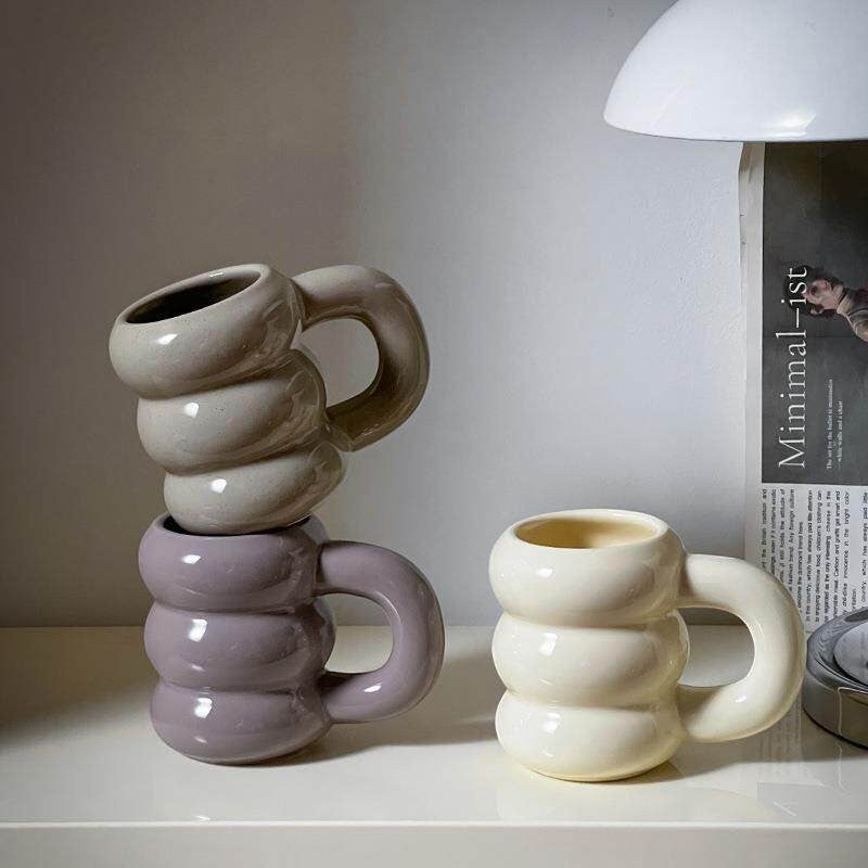 HOMELIVY Nordic Sculptural Bubble Coffee Mug in cream and lilac ceramic with oversized handle. Modern design.