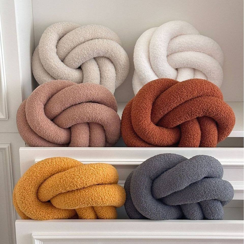 HOMELIVY Nordic knot cushion pillow in boucle fabric, available in cream, pink, rust, yellow, and grey.
